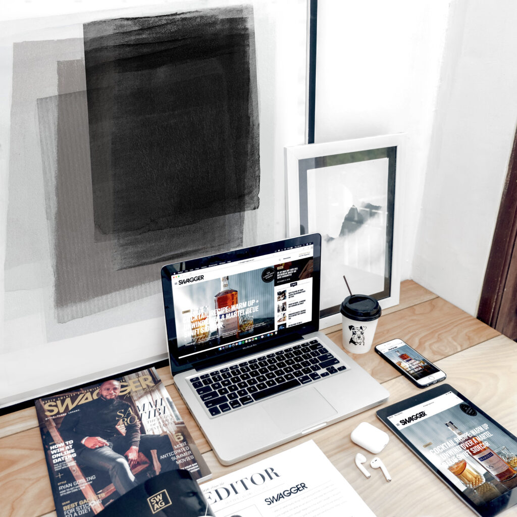 Macbook pro surrounded by assorted items